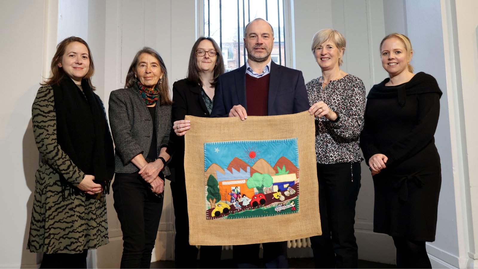 (L-R): Lauren Dempster, QUB; Roberta Bacic, Conflict Textiles (CT); Karen Logan, Ulster Museum (UM); Patrick Corrigan, Amnesty International NI, Gillian Robinson, CT and Hannah Crowdy, UM; marking the transfer of 14 textiles from CT to UM. (Photo: UM)