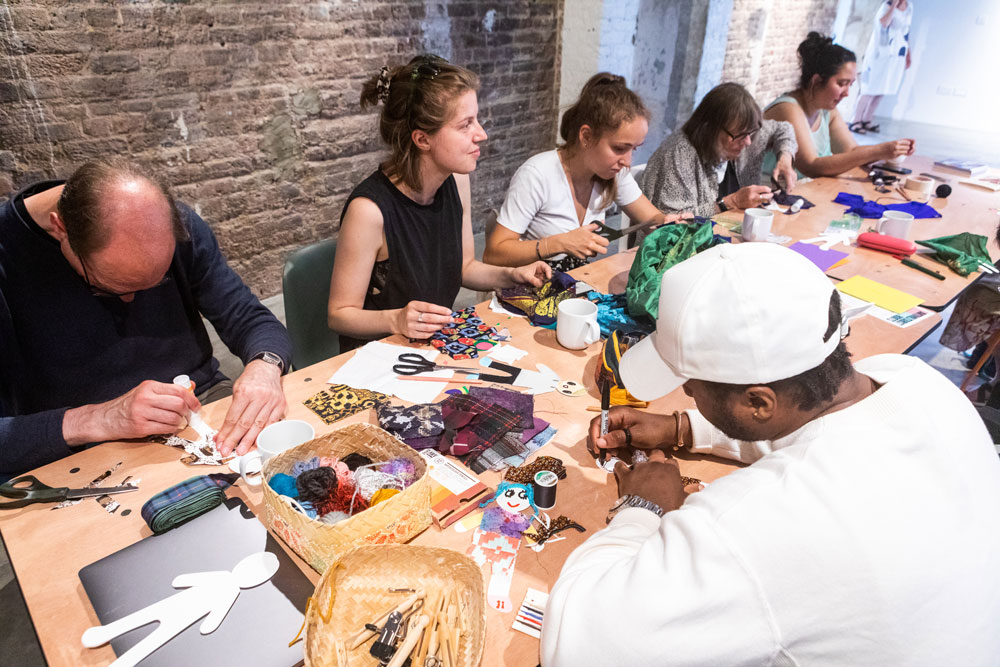 Participants engrossed in the 'Afghani War Rugs Reimagined' workshop, facilitated by Conflict Textiles curator, Roberta Bacic. (Photo: Maryna Sulym)